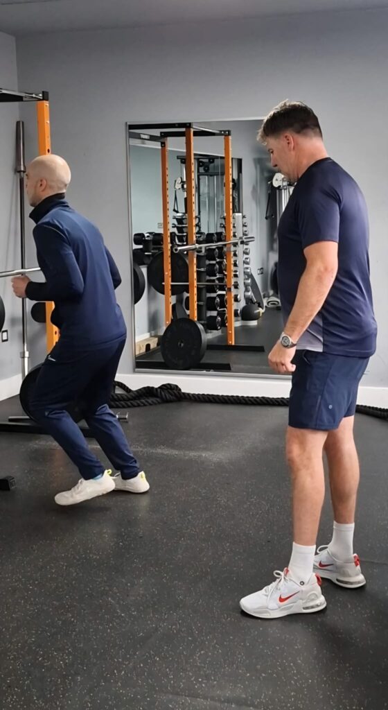 Personal Trainer demonstrating an exercise in a private gym in Poole.