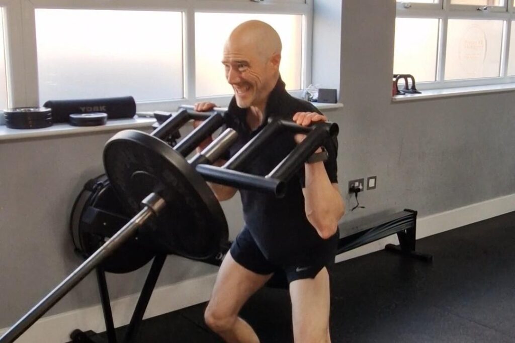 Dom Meacher performing a landmine press at Ocean Fitness Poole
